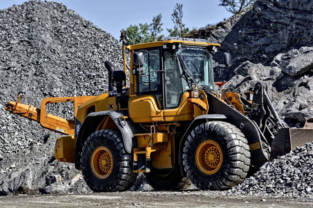 Mastering the First Impression: Your intriguing post title goes here Powerful yellow construction loader moving gravel in an industrial quarry site.